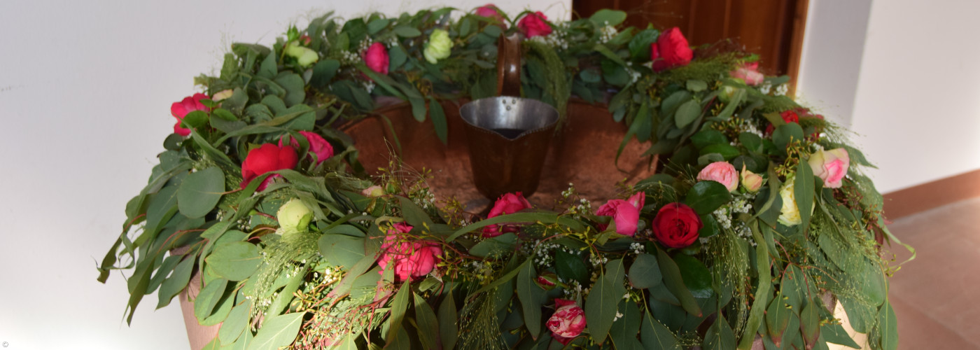 Blumenschmuck auf Taufstein